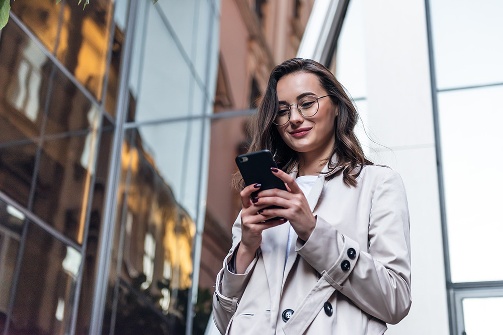 business woman walking outside in new york on her phone