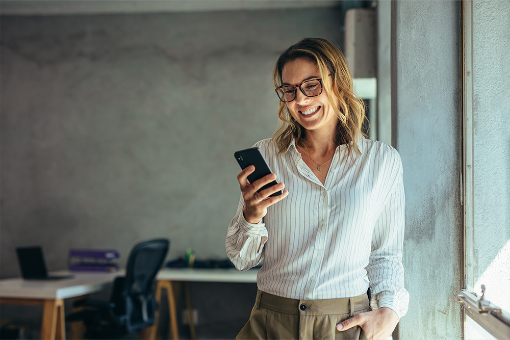 professional woman smiling looking at phone
